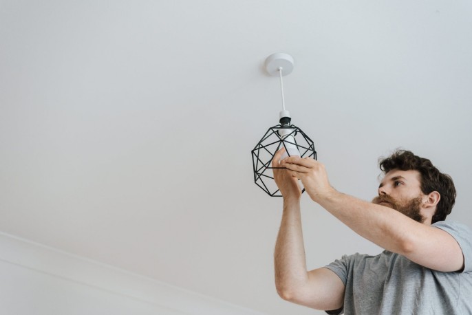 Man fixing light fitting